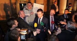 David Finn interrupts Alan Kelly to discuss the homelessness crisis outside a forum at the Custom House. Picture: Collins &