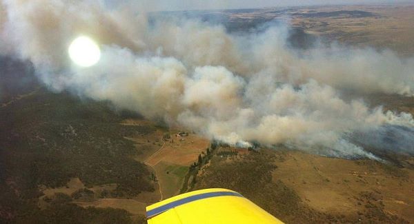 In this photo provided by the New South Wales Rural Fire Service, plumes of smoke rise from a fire near Cooma, Australia today.