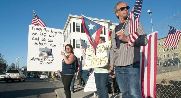Protesters stand outside the funeral home in Worcester, Mass. Picture: AP