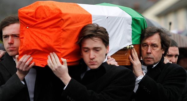 Dolours Price's coffin is carried by her two sons Danny and Oscar at front and her ex-partner, actor Stephen Rea (rear right).