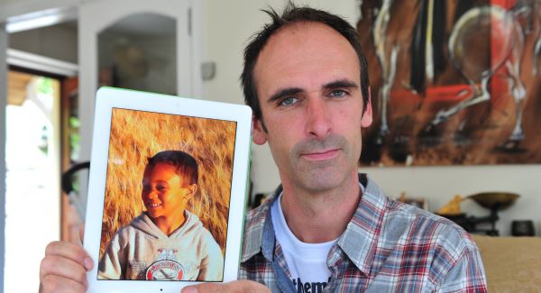 Richard Quarry holding a picture of his son Ethan, 7, in Kinsale, Co Cork, who was taken to Zambia in spite of his mother having lost custody. Picture: Dan Linehan