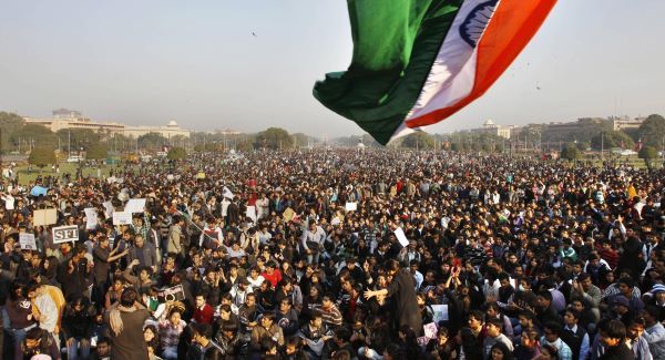 Protesters gather under an Indian flag near the Presidential Palace during a protest in New Delhi this weekend. Picture: AP