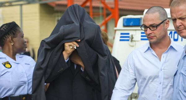 Oscar Pistorius (centre) is led from the Boschkop police station east of Pretoria, en route to court today. Picture: AP