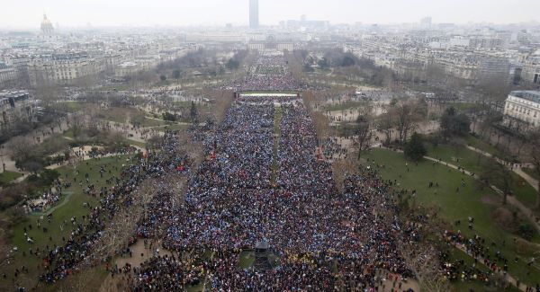 Overhead view from the Eiffel Tower of thousands of people gathering to protest on the "Champs de Mars"