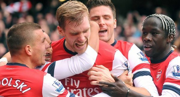 Arsenal's Per Mertesacker (centre) is mobbed by his team mates after scoring Arsenal's first goal today. Picture: PA